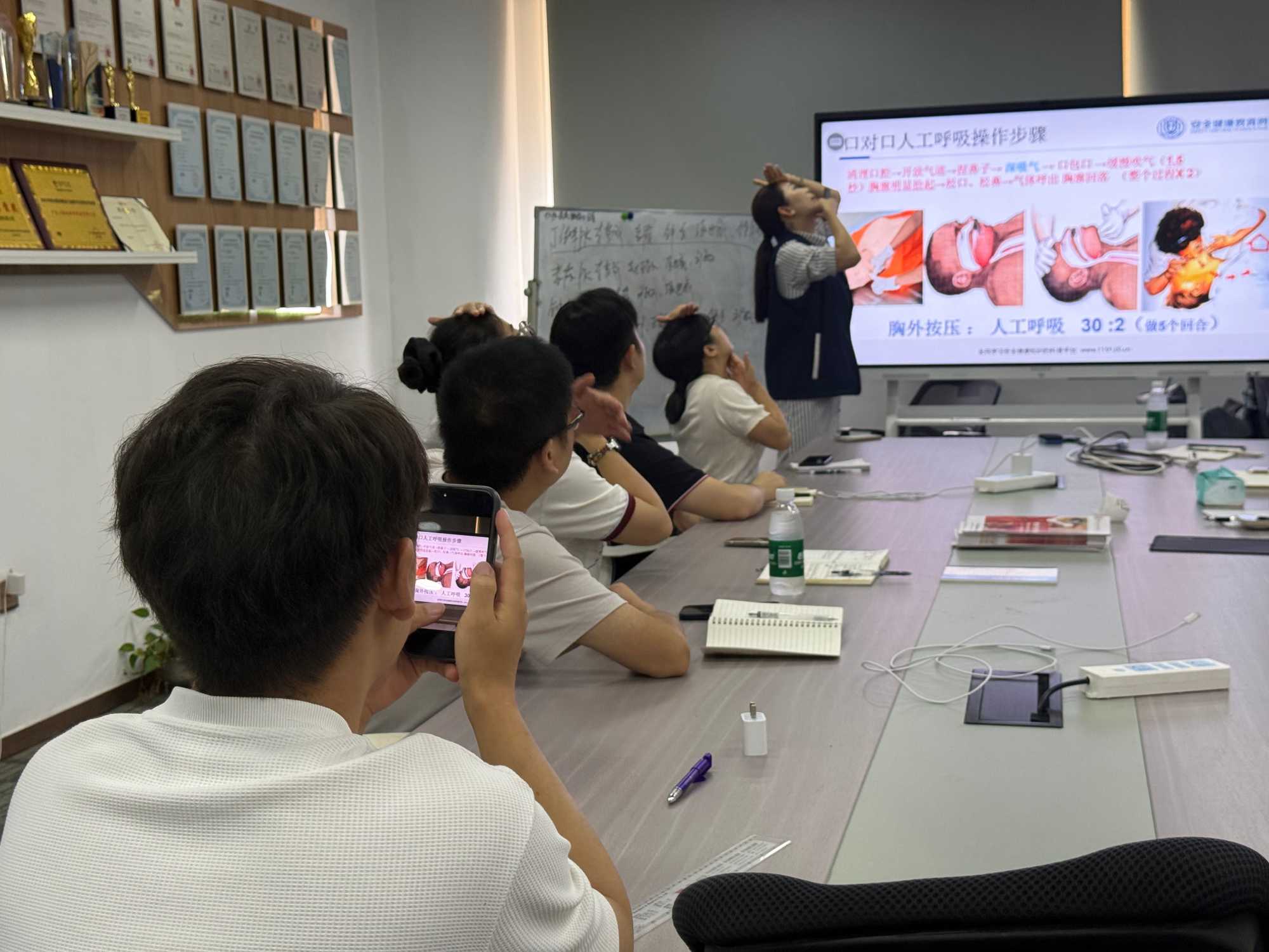 Employees learning CPR during Xiaota first aid training